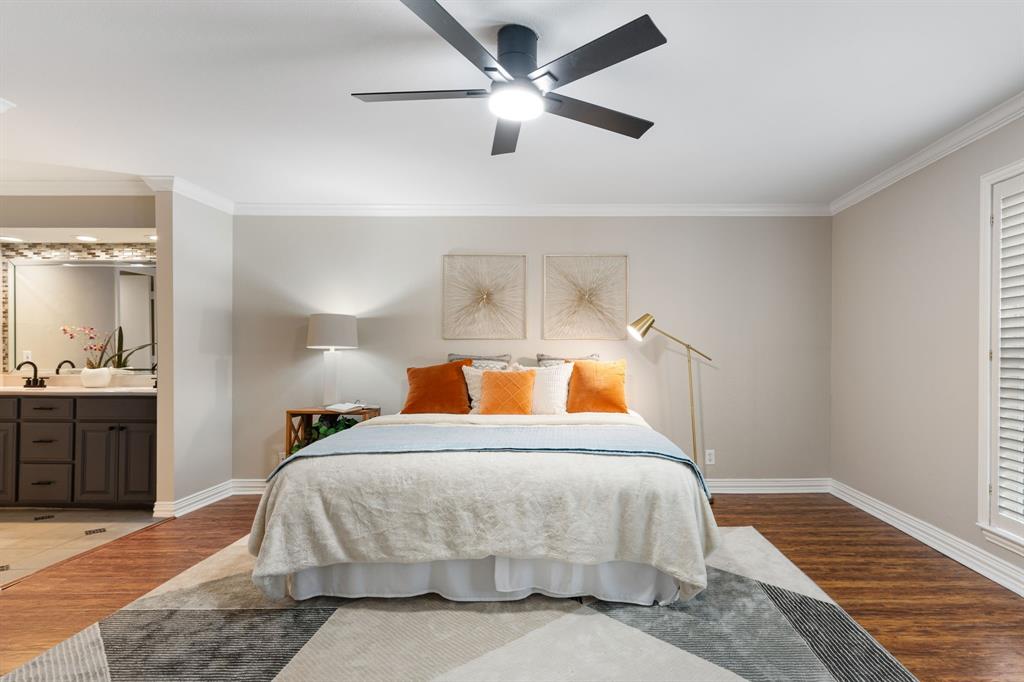 15923 Preston Road, Unit 1003 Dallas, TX 75248 - Photo 19 of 36 a bedroom with a bed and wooden floor