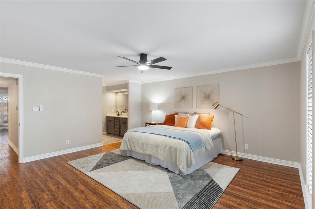 15923 Preston Road, Unit 1003 Dallas, TX 75248 - Photo 21 of 36 a bedroom with a large bed and a chandelier