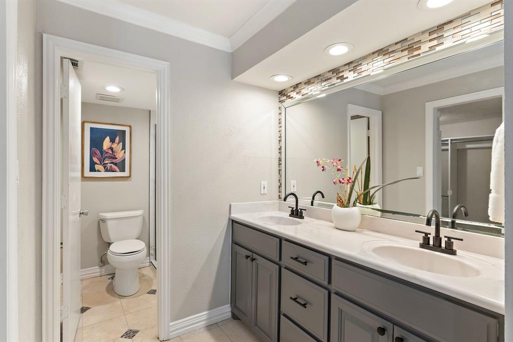15923 Preston Road, Unit 1003 Dallas, TX 75248 - Photo 23 of 36 a bathroom with a double vanity sink toilet and a mirror
