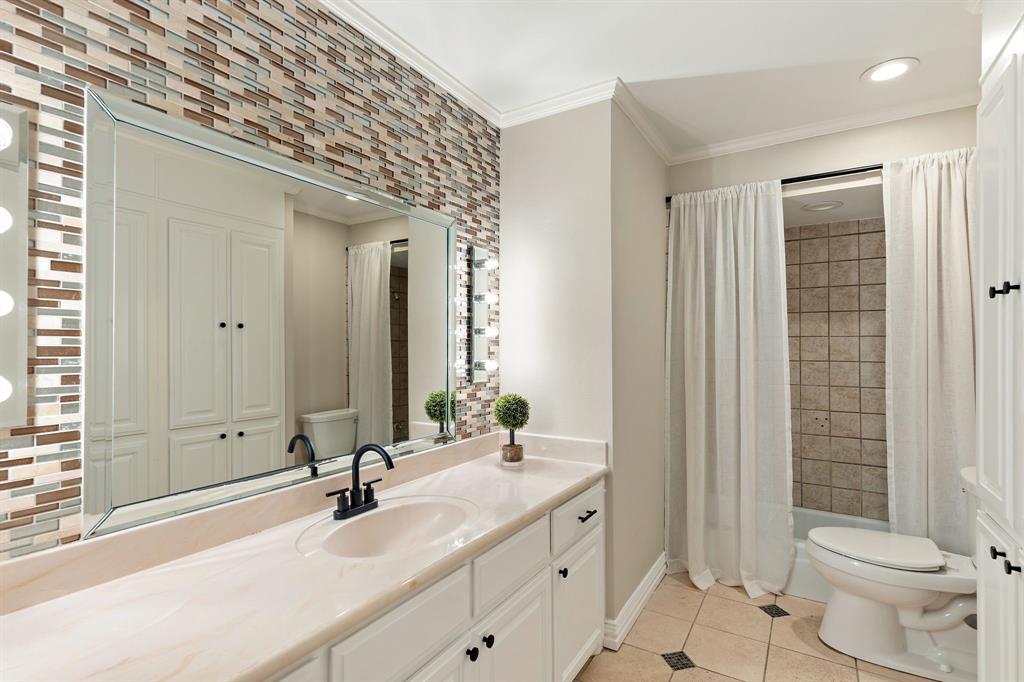 15923 Preston Road, Unit 1003 Dallas, TX 75248 - Photo 29 of 36 a bathroom with a double vanity sink toilet and shower