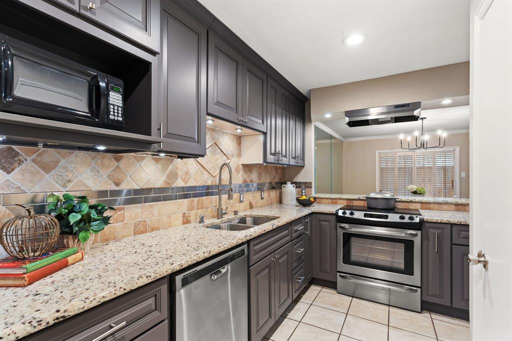 15923 Preston Road, Unit 1003 Dallas, TX 75248 - Photo 9 of 36 a kitchen with granite countertop stainless steel appliances and cabinets