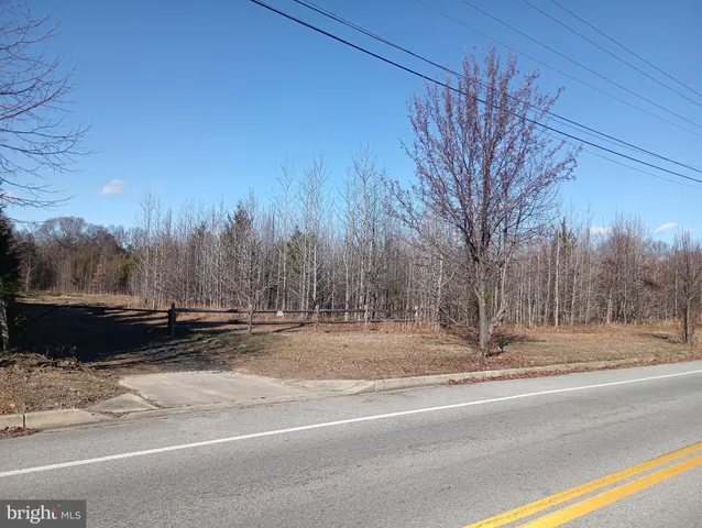 a view of street with a cars parked on road
