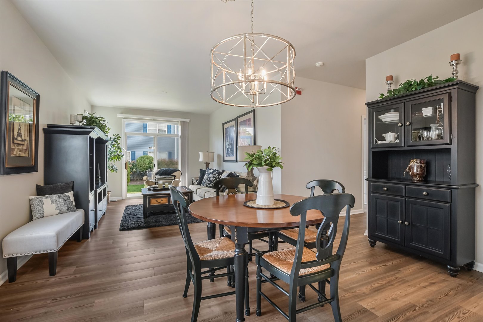 2562 Golf Ridge Circle, Unit 2562 Naperville, IL 60563 - Photo 7 of 22 a view of a dining room with furniture a chandelier and wooden floor