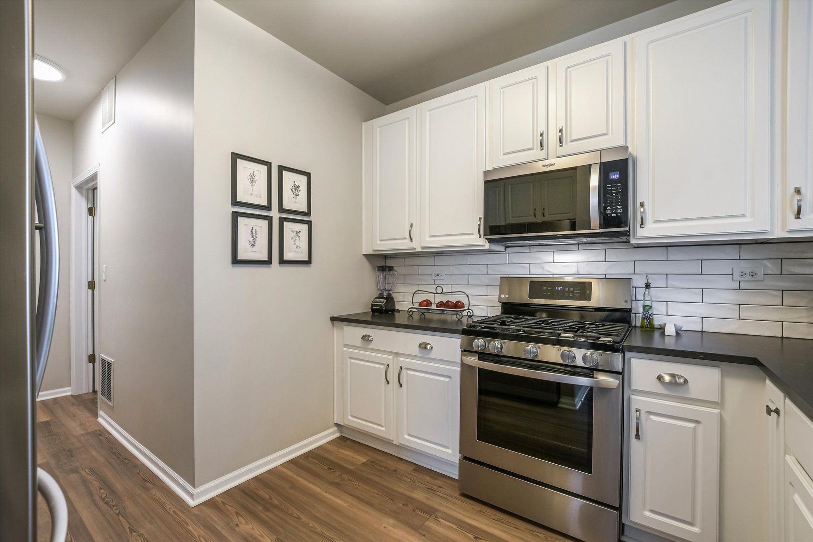 2562 Golf Ridge Circle, Unit 2562 Naperville, IL 60563 - Photo 10 of 22 a kitchen with stainless steel appliances granite countertop white cabinets a stove top oven