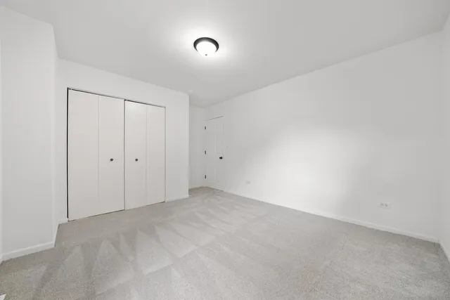 a white toilet sitting in a bathroom next to a window