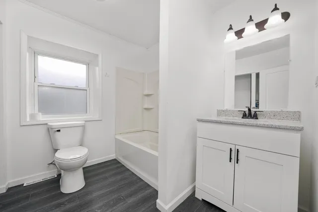 an aerial view of a house with a yard and outdoor seating