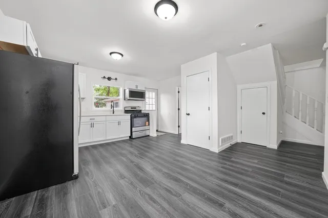 a view of a kitchen with wooden floor