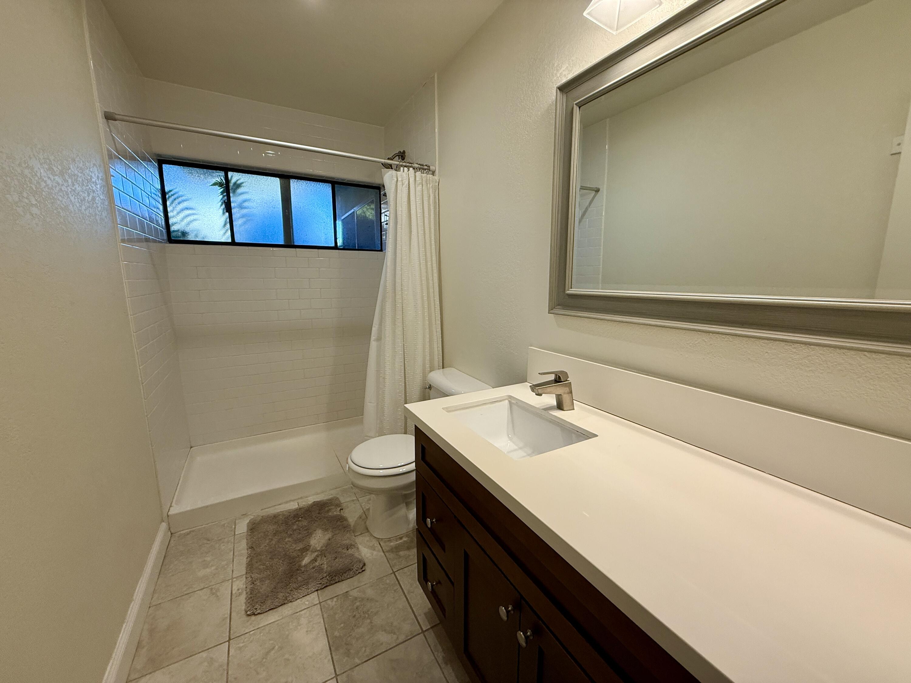 3375 Foothill Road, Unit 511 Carpinteria, CA 93013 - Photo 11 of 13 a bathroom with a sink a toilet and shower