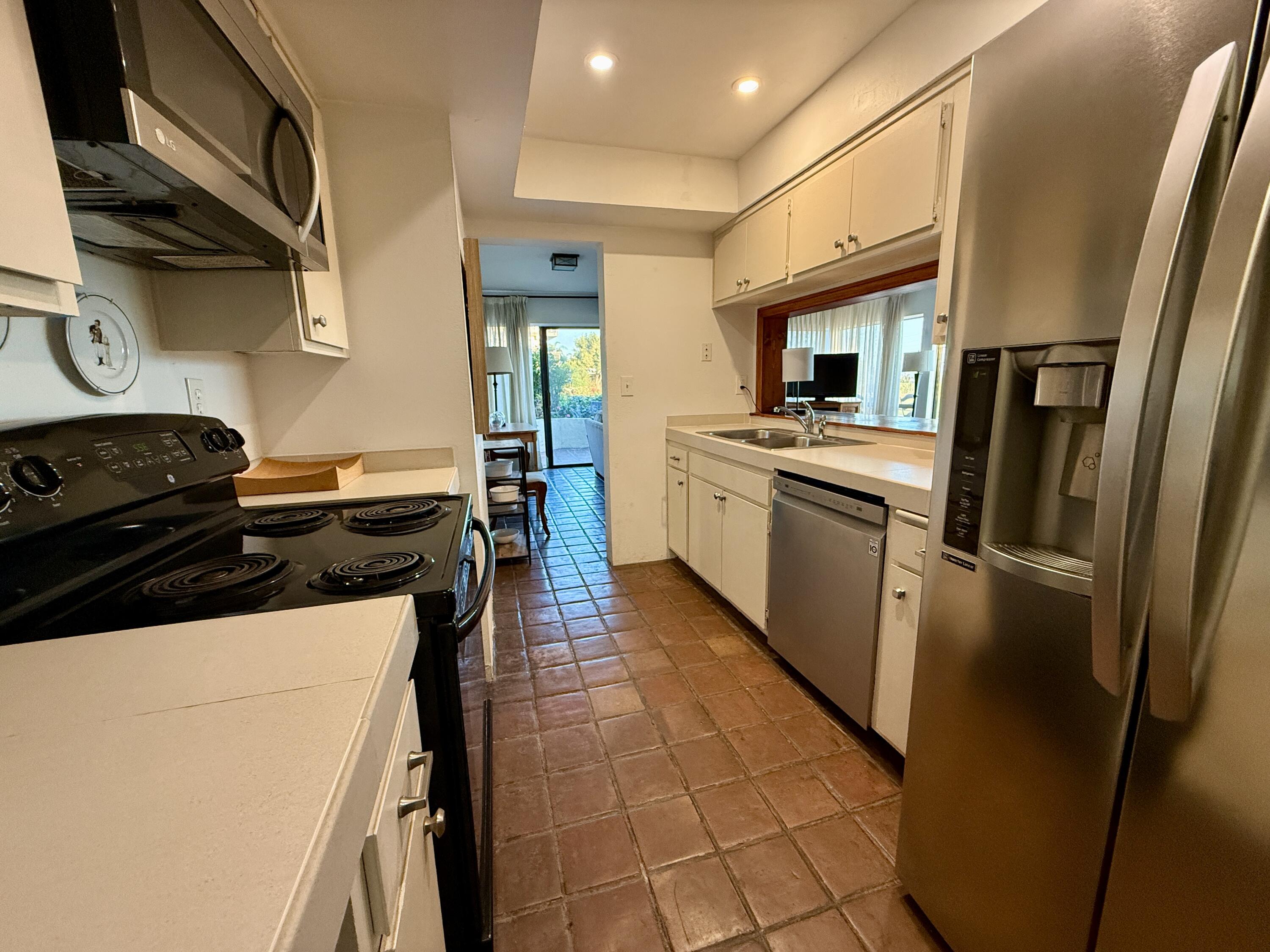 3375 Foothill Road, Unit 511 Carpinteria, CA 93013 - Photo 6 of 13 a kitchen with stainless steel appliances granite countertop a stove a refrigerator and a sink