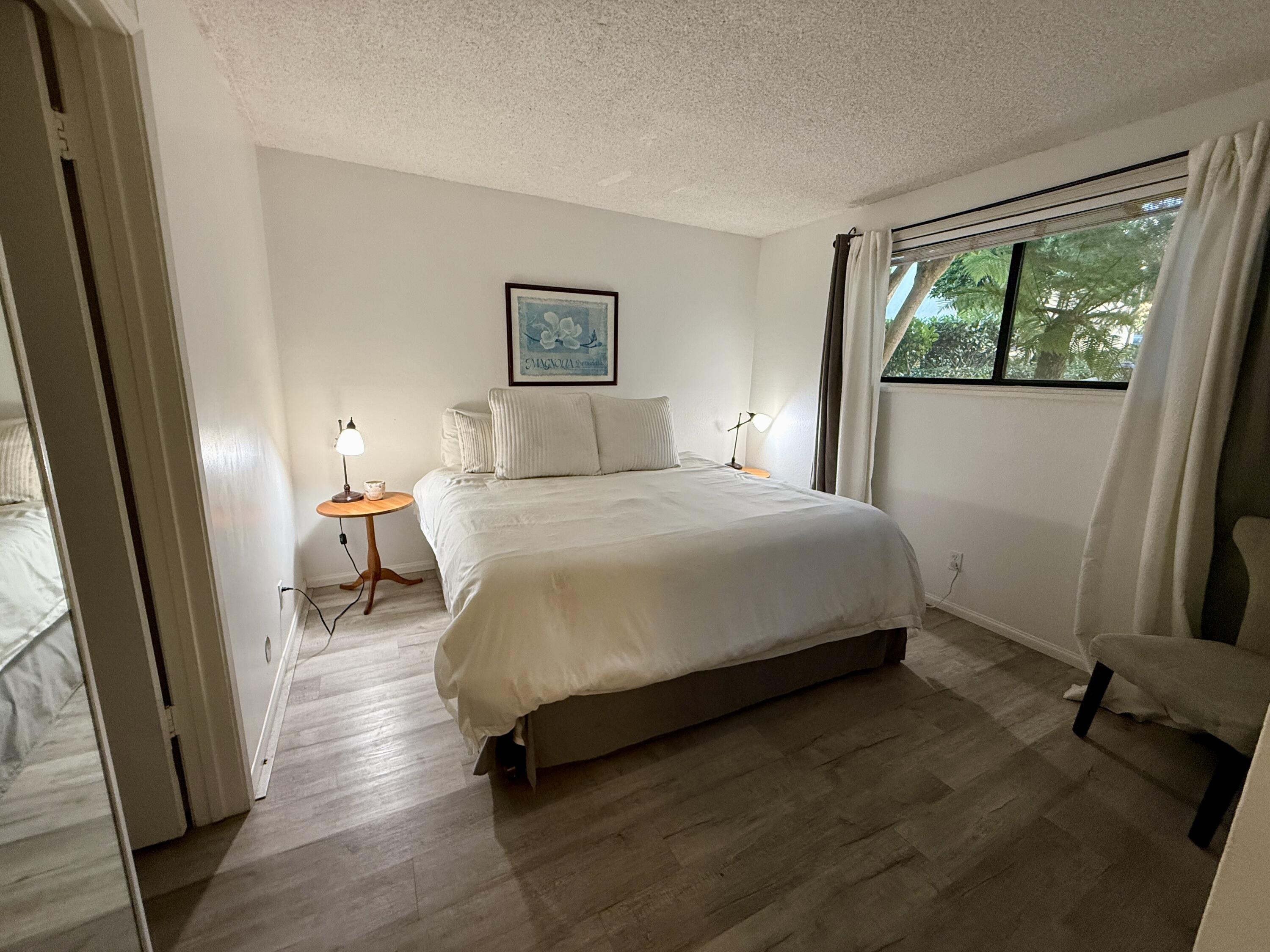3375 Foothill Road, Unit 511 Carpinteria, CA 93013 - Photo 7 of 13 a bedroom with a bed a mirror and a window