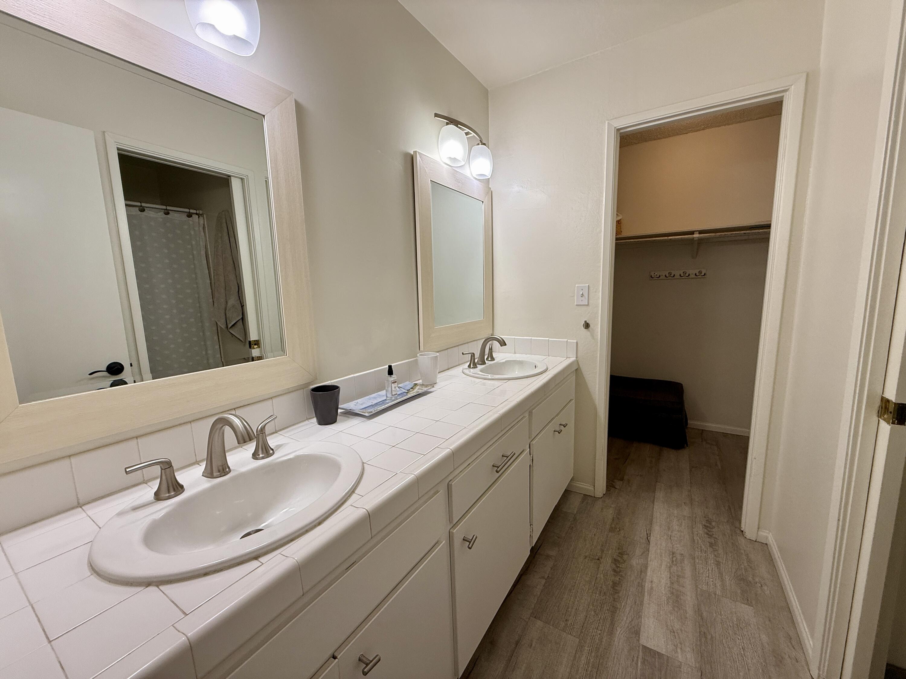 3375 Foothill Road, Unit 511 Carpinteria, CA 93013 - Photo 9 of 13 a bathroom with a double vanity sink and a mirror