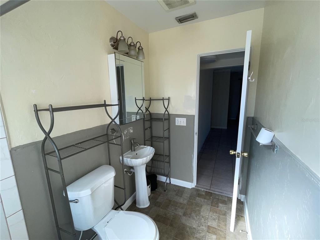 632 Cardinal Street Ocoee, FL 34761 - Photo 11 of 29 a white toilet sitting next to a bathroom sink