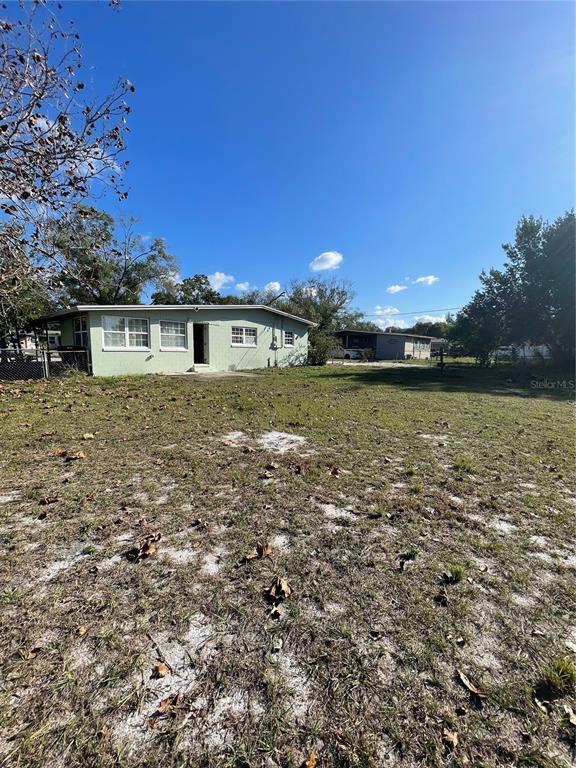 632 Cardinal Street Ocoee, FL 34761 - Photo 15 of 29 a view of a house with a yard and a large tree