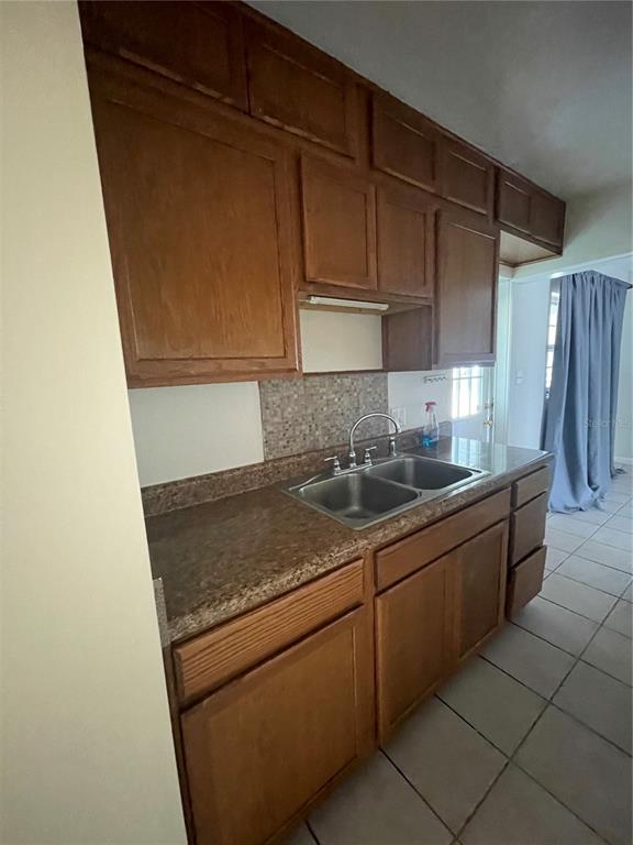 632 Cardinal Street Ocoee, FL 34761 - Photo 22 of 29 a kitchen with granite countertop a sink and a stove