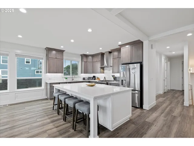 a large kitchen with a table and chairs