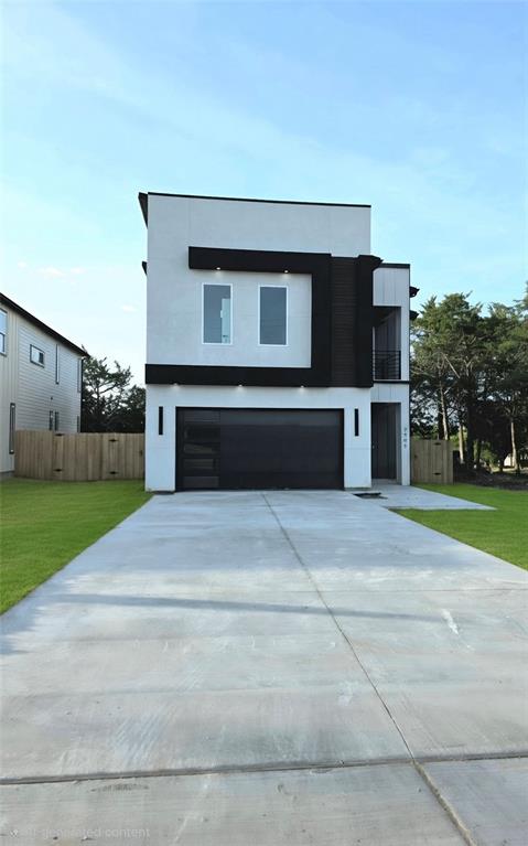 3905 Blue Ridge Boulevard Dallas, TX 75233 - Photo 1 of 9 Contemporary facade featuring white stucco, black accents, and a large integrated garage