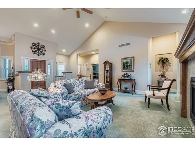 a view of a dining room with furniture and a chandelier