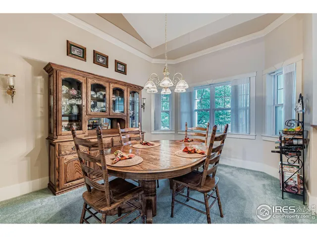 a living room with furniture a fireplace and a chandelier