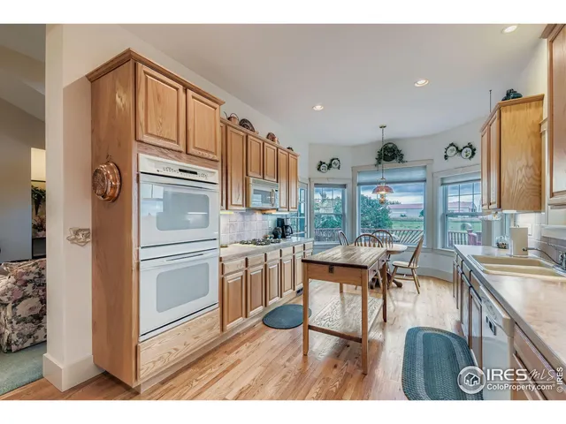 a kitchen with stainless steel appliances kitchen island granite countertop a sink and cabinets