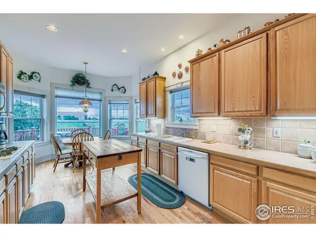 a dining room with furniture a chandelier and wooden floor