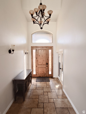 552 Sunset Crest Way Draper, UT 84020 - Photo 16 of 68 Entryway featuring a chandelier, a high ceiling, french doors, and stone tile flooring