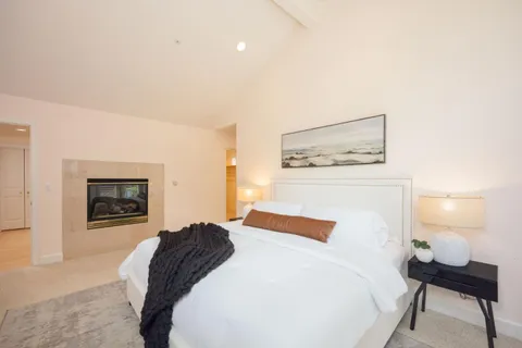 a bedroom with a bed and a lamp on table