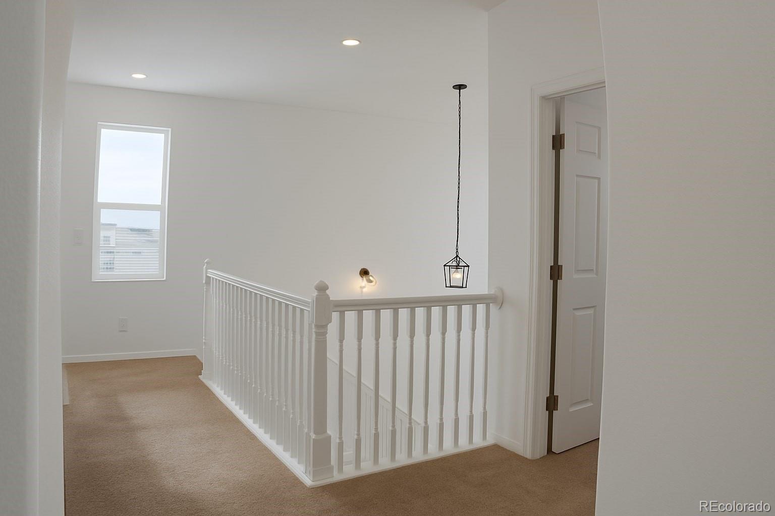 3607 East Uintah Street, Unit 102 Colorado Springs, CO 80909 - Photo 13 of 21 a view of a hallway with windows
