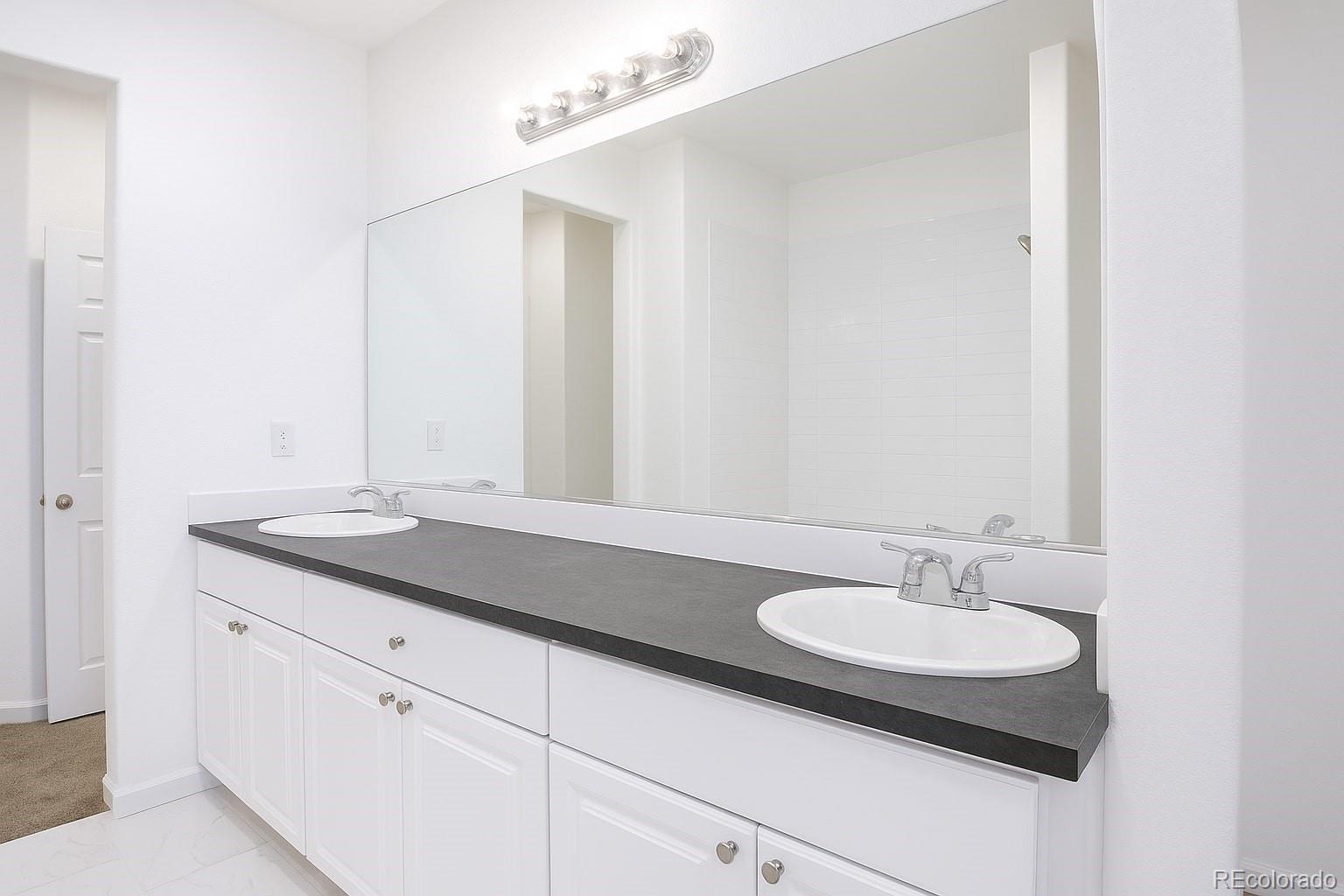 3607 East Uintah Street, Unit 102 Colorado Springs, CO 80909 - Photo 17 of 21 a sink and a mirror