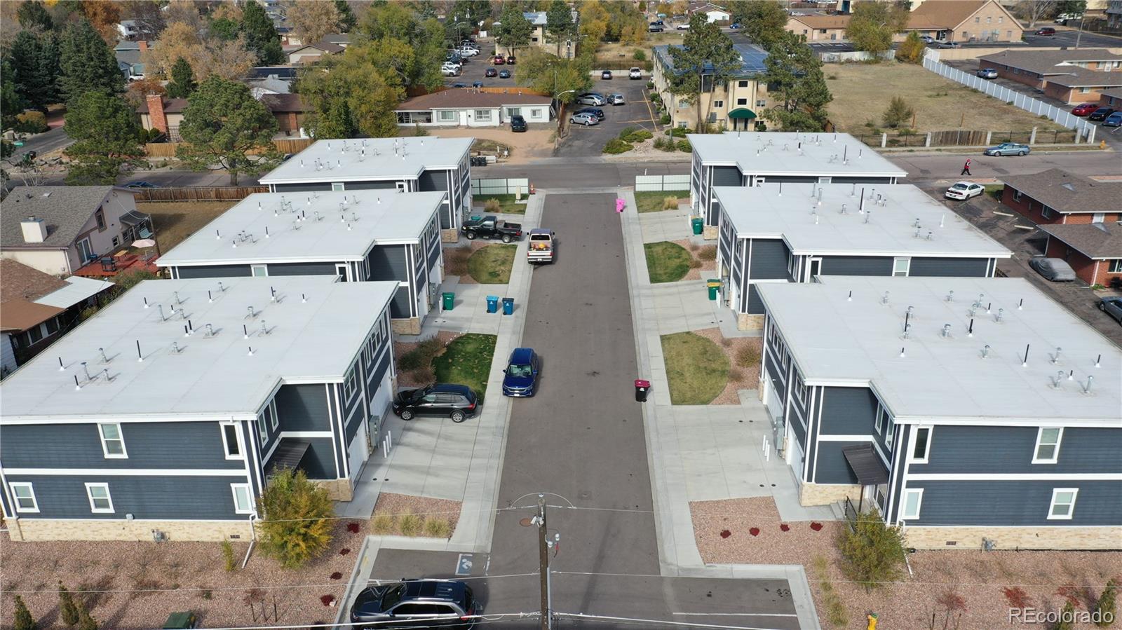 3607 East Uintah Street, Unit 102 Colorado Springs, CO 80909 - Photo 21 of 21 an aerial view of residential houses with outdoor space