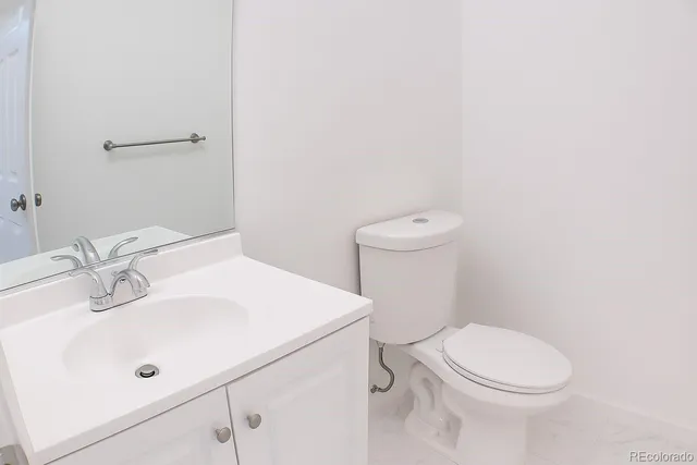 a white toilet sitting next to a bathroom sink
