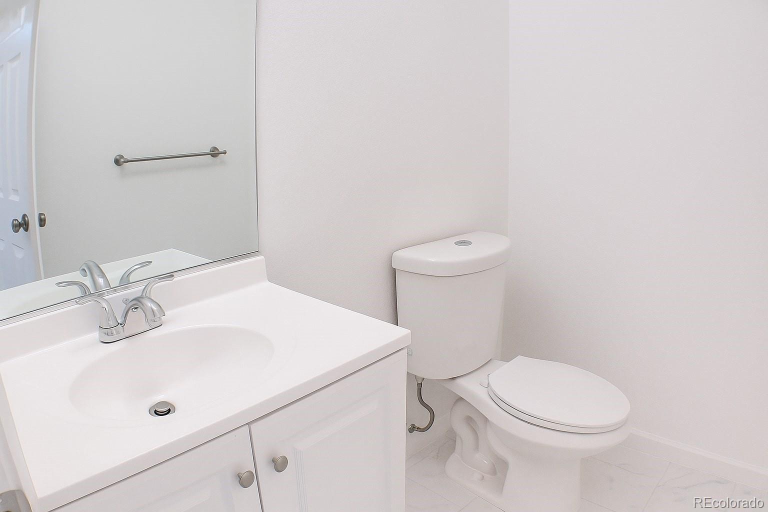 3607 East Uintah Street, Unit 102 Colorado Springs, CO 80909 - Photo 4 of 21 a white toilet sitting next to a bathroom sink