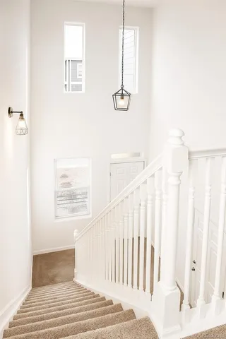 a view of a hallway with windows and stairs