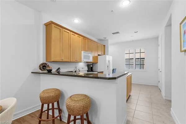 a kitchen with stainless steel appliances granite countertop a sink and cabinets