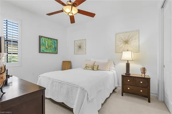 a bedroom with a bed and a desk