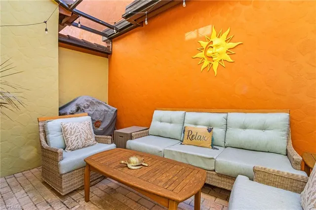 a blue couch sitting in front of a blue wall with a dining table and chair