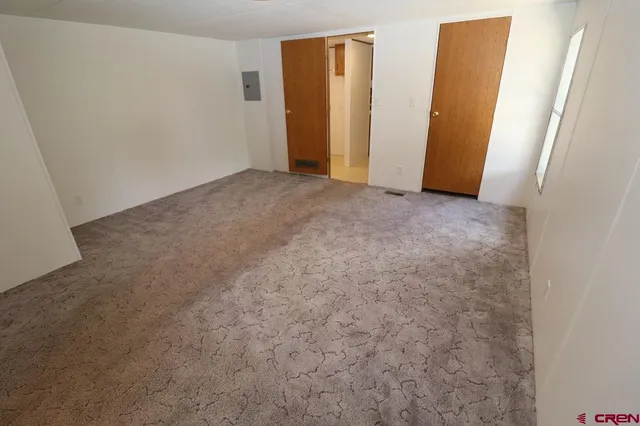 a view of a room with wooden floor