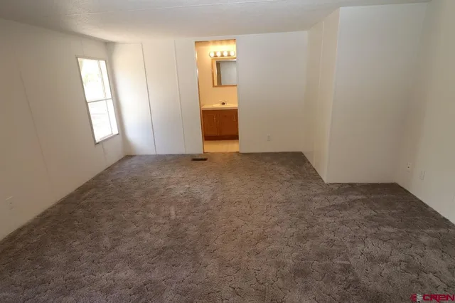 an empty room with windows and entrance