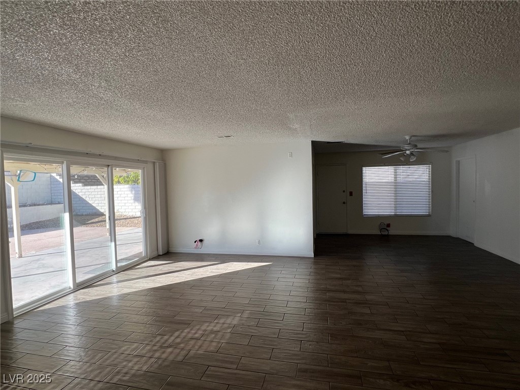 3737 Prosperity Lane Las Vegas, NV 89147 - Photo 11 of 36 Unfurnished room featuring wood tiled floors, a textured ceiling, and ceiling fan