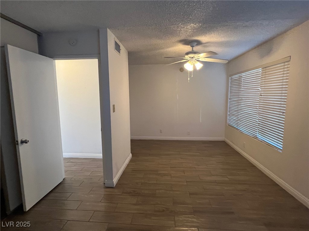 3737 Prosperity Lane Las Vegas, NV 89147 - Photo 32 of 36 Unfurnished room with dark wood finished floors, a textured ceiling, and ceiling fan