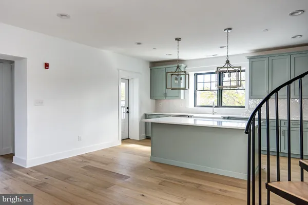 a kitchen with granite countertop a stove a sink and a window