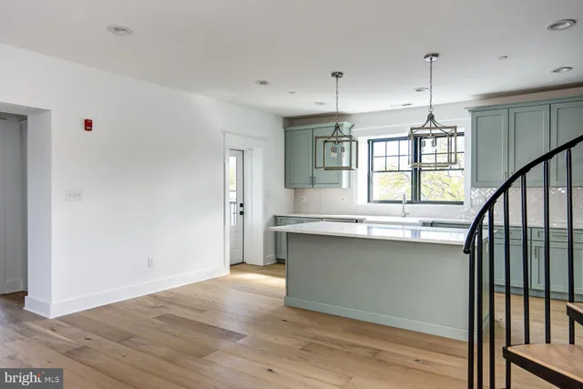a kitchen with granite countertop a stove a sink and a window