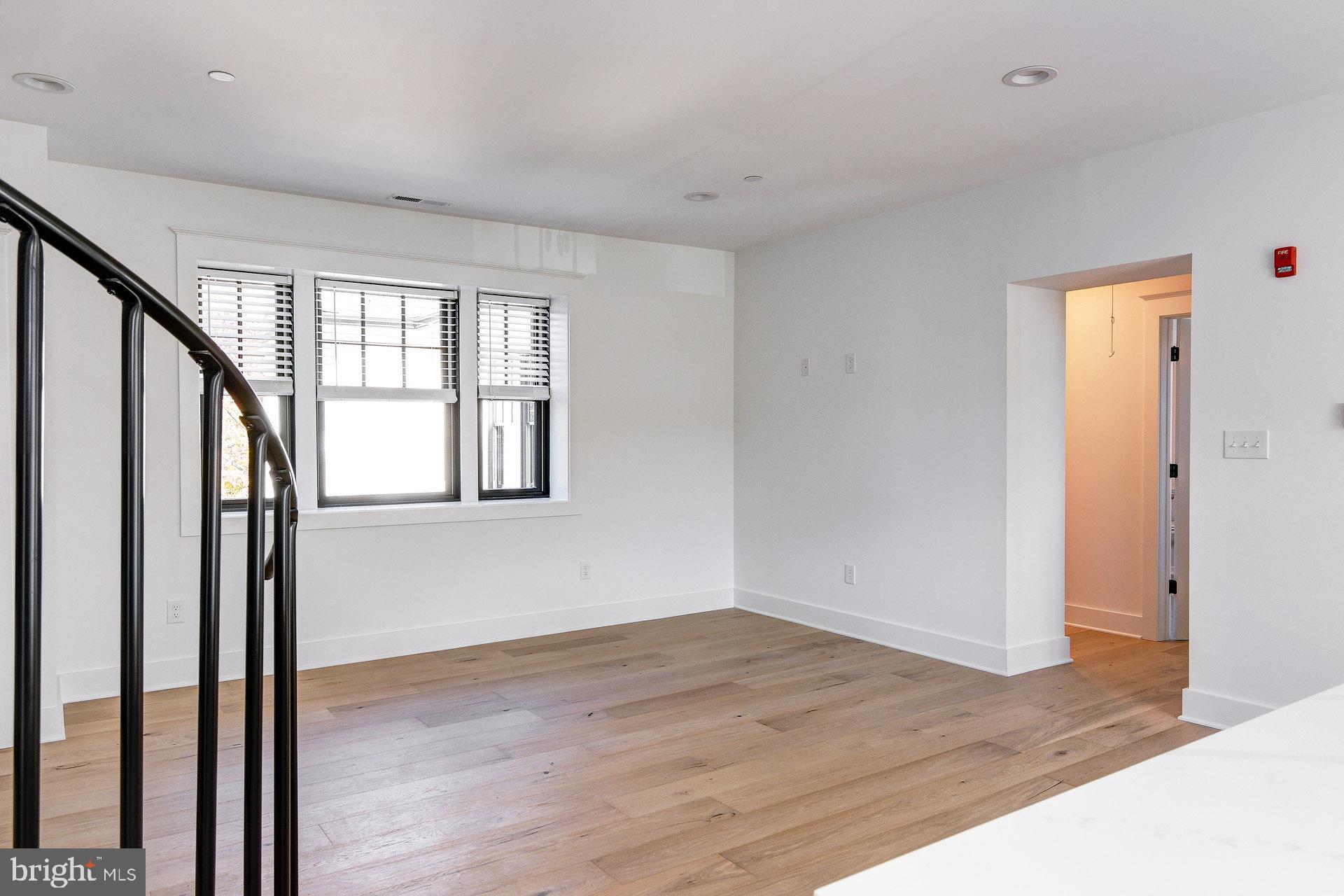 20 East Redman Avenue, Unit C Haddonfield, NJ 08033 - Photo 13 of 43 a view of an empty room with wooden floor and a window