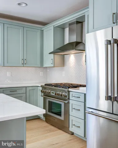 a kitchen with a stove and a refrigerator