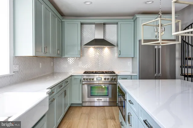 a kitchen with a stove and a refrigerator