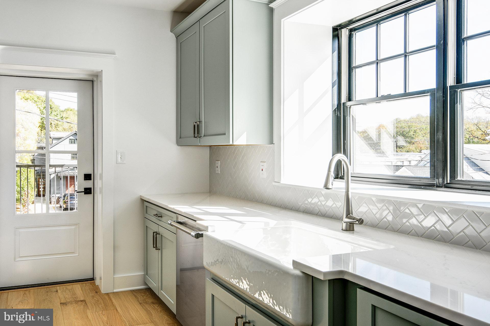 20 East Redman Avenue, Unit C Haddonfield, NJ 08033 - Photo 17 of 43 a kitchen with granite countertop a sink and a window