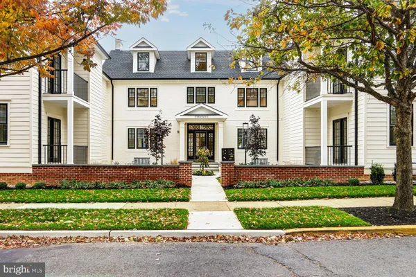 front view of a brick house with a yard