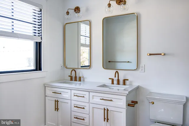 a bathroom with a sink vanity and mirror