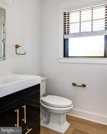 a bathroom with a toilet a sink and a window