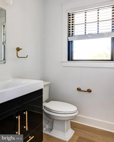 a bathroom with a toilet a sink and a window