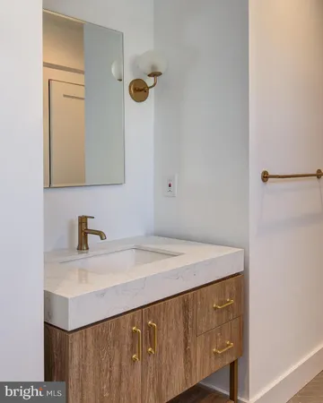 a bathroom with a sink vanity and a mirror